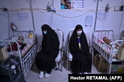 Women sitting next to their babies receiving treatment for malnutrition at a Doctors Without Borders (MSF) nutrition center in the western city of Herat in November.