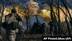 Ukrainian soldiers fire a self-propelled howitzer toward Russian positions near Bakhmut, Donetsk region, the epicenter of the war in Ukraine's eastern region of Donetsk.