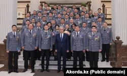 Toqaev poses with employees of the state security service in Astana on April 21, 2022.