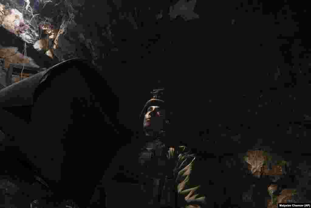 A Ukrainian soldier takes cover in a bunker at the front line in Andriyivka on September 16. The goal of the brigade has been the capture of Andriyivka. After more than three months of battle, they finally broke through the shelling and the drone-launched grenades, firing at the Russian forces who fled in front of them.