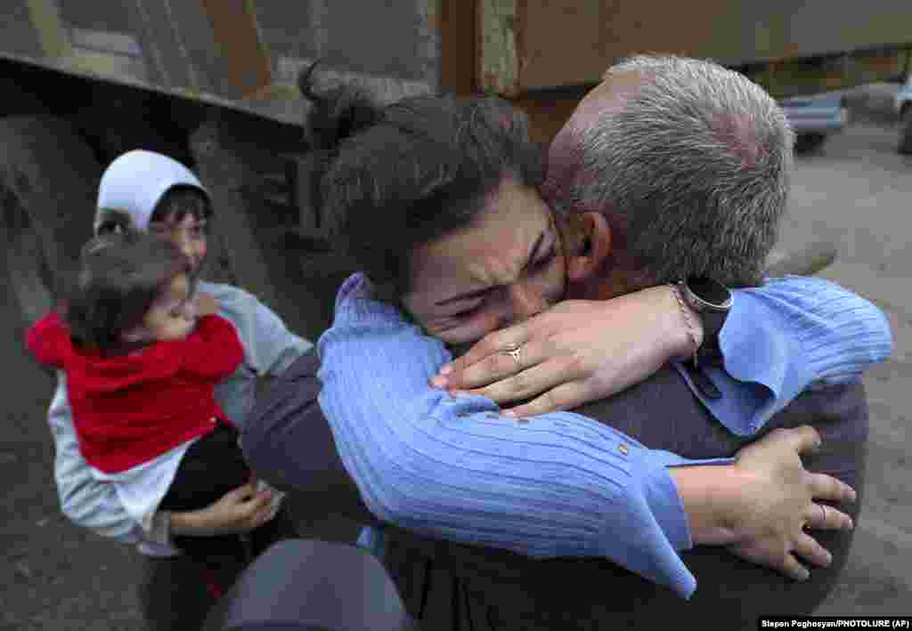 Armenians embrace after arriving in Kornidzor, Armenia. 