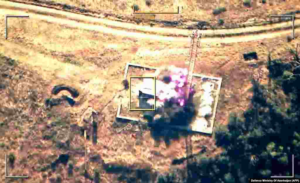 Handout footage released by the Azerbaijani Defense Ministry on September 19 shows an explosion in mountainous terrain that Baku claims to be Azerbaijani forces "destroying positions" used by Armenians in the Nagorno-Karabakh region. 
