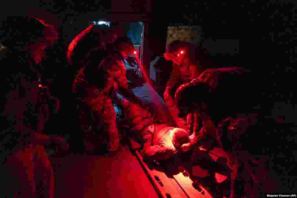 Ukrainian paramedics carry a wounded comrade injured during fighting near Andriyivka. The brigade's two-month battle to fight its way through a charred forest and entrenched enemy positions shows the challenges of Kyiv's counteroffensive in the east and south. 