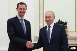 Владимир Путин (справа) пожимает руку президенту Сирии Башару Асаду во время их встречи в Кремле. Москва, 24 июля 2024 года