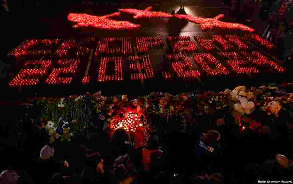Lit candles forming the words "We Mourn 22.03.2024" are placed outside the Crocus City Hall concert venue on a national day of mourning on March 24.