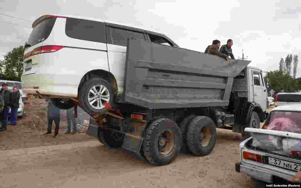A truck carrying a minivan and refugees arrives in Armenia. Prior to its offensive, Azerbaijan had maintained a monthslong blockade of Nagorno-Karabakh, claiming it had concerns about illicit weapon shipments, which cut the 120,000 residents off from essential supplies. 