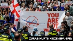 People protest the resumption of air links with Russia during the arrival of the first direct flight from Moscow to Tbilisi on May 19.