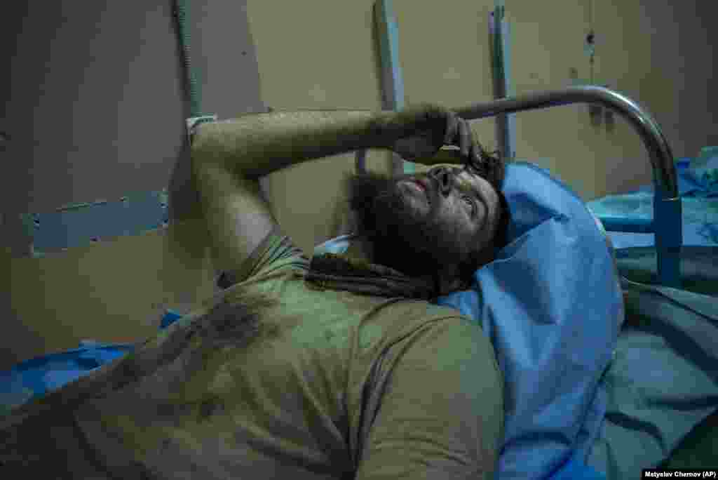 An injured soldier lies on a bed at a field hospital on September 12. The soldiers sent to carry out the task are relying on largely Soviet-era armored vehicles and older weapons. In the past month, the brigade had only been able to move 2 kilometers, crossing mines and booby-trapped trenches and dodging artillery, drone-launched grenades, and Russian forces within shouting distance.