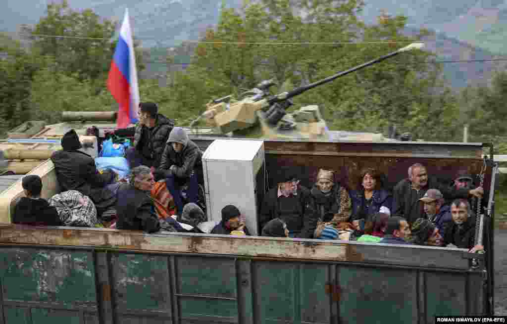 Armenian refugees sit in the back of a truck at the Lachin checkpoint, controlled by Russian peacekeepers and Azerbaijani border guards, as they wait to cross into Armenia. Baku has pledged equal treatment for ethnic Armenians, but Yerevan has warned of possible "ethnic cleansing." 