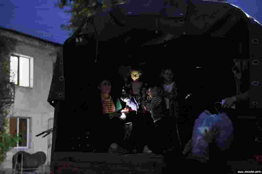 Refugees wait in a truck in Goris, in southern Armenia, before moving on to Yerevan. U.S. Secretary of State Antony Blinken told Azerbaijani President Ilham Aliyev on September 26 that he must protect civilians in Nagorno-Karabakh. 