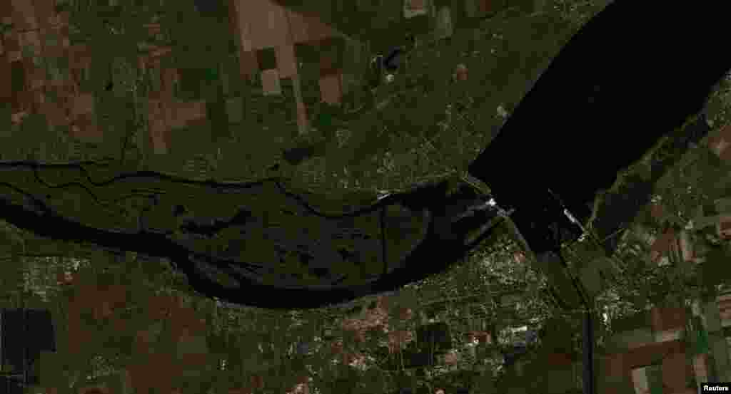 A satellite image shows the Nova Kakhovka dam and the surrounding Kherson region on October 18, 2022. Worst-case modelling following the destruction of the dam predicted that flooding would take place on the left (southeast) side of the river bank. A 4-to-5-meter wave would hit the Antonivskiy Bridge east of Kherson city about 19 hours later, there would be a back swell flooding up the Inhulets River, and after four or five days there would be some flooding up the Bug River to Mykolayiv. 