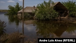 A flooded cottage in the village of Odradokamyanka that had earlier been damaged by shelling.