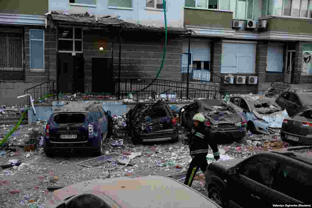 A firefighter walks near cars damaged during the Russian drone strike. Russia has intensified missile and drone strikes on Ukraine after a lull of nearly two months, targeting military facilities and supplies with waves of attacks several times a week. 