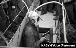 A pistol-wielding man emerges from a subway construction site during the chaos of the 1956 uprising.