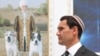 Turkmen President Serdar Berdymukhammedov with a portrait of his father, Gurbanguly, in the background. (file photo)