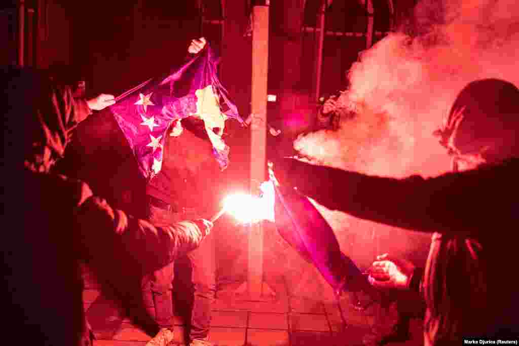 A protester burns a Kosovo flag in Belgrade on December 12. EU foreign policy chief Josep Borrell has called for de-escalation from both Kosovo and Serbia, while Serbian President Aleksandar Vucic has called for the deployment of Serbian troops to northern Kosovo, fueling fears of a new war.