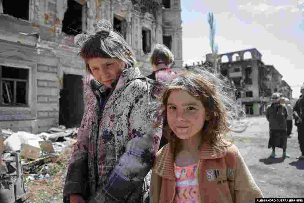 Children from Mariupol walk near the celebrations on May 9. Beleaguered residents who have survived the Russian bombardment were encouraged to participate with promises of free food and entertainment.