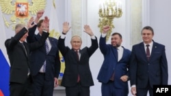 The Moscow-appointed heads (left to right) of the Kherson region, Vladimir Saldo, and Zaporizhzhya region, Yevgeny Balitsky, jRussian President Vladimir Putin, Donetsk separatist leader Denis Pushilin, and Luhansk separatist leader Leonid Pasechnik react after signing treaties formally annexing the regions in Moscow on September 30.