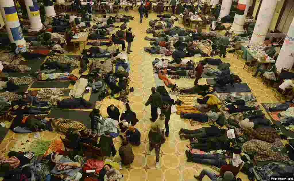 Pro-European protesters sleep inside Kyiv City Hall on December 7, 2013. Thousands of protesters gathered in Kyiv to demand the government's resignation and early elections. They blocked the cabinet of ministers' building and occupied a labor-union building and the city administration, where they had hoisted the EU flag a day earlier.