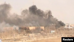 Clouds of smoke rise from the Kazakh town of Zhanaozen in December 2011 in a still image taken from video acquired by Reuters TV.