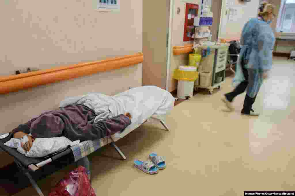 A coronavirus patient lies on a stretcher bed in a hallway of the Matei Bals Institute for Infectious Diseases in Bucharest on October 11. 
