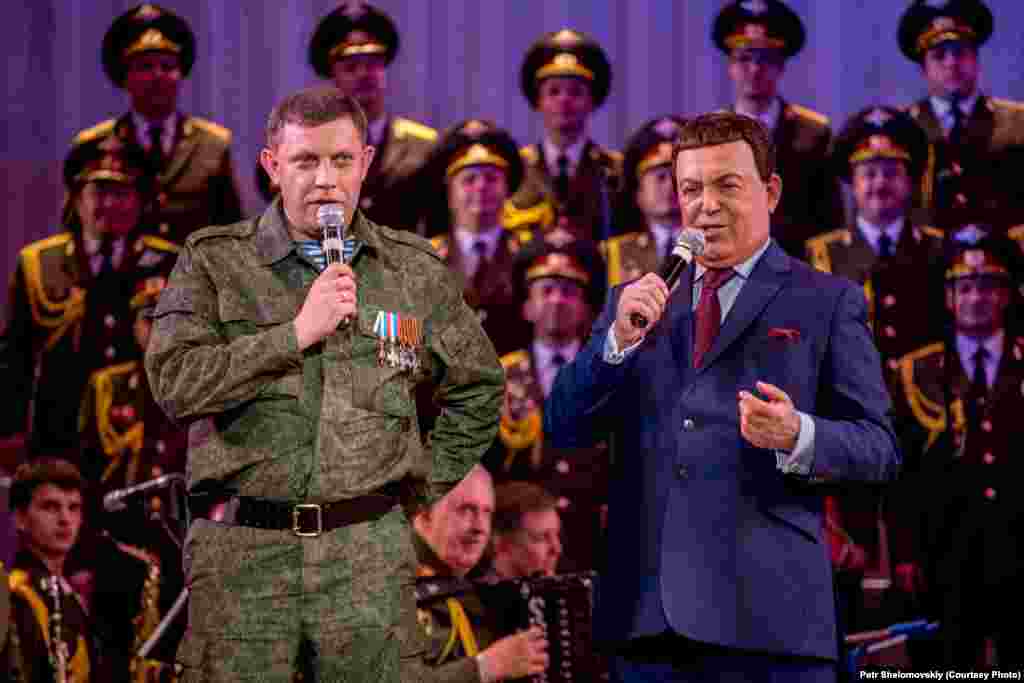 Iosif Kobzon, a singer known for his loyalty to the Kremlin, and Aleksandr Zakharchenko, prime minister of the self-proclaimed Donetsk People's Republic, sing a Soviet-era song together during a concert in Donetsk. 