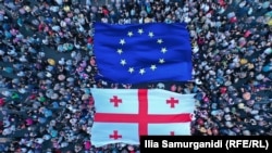 Participants carry EU and Georgian flags at a rally in support of European integration in Tbilisi on July 3, 2022.