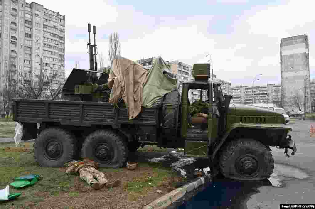 Bodies of Russian servicemen, wearing Ukrainian uniforms, inside and beside a vehicle. They were shot during a skirmish in the Ukrainian capital, Kyiv, on February 25.
