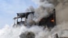 An unknown number of people were trapped under rubble after a blast and subsequent fire at the Surmalu market sent a towering cloud of smoke over Yerevan. 