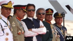 Pakistani Prime Minister Imran Khan (third left) and President Arif Alvi (third right) watch Pakistani Air Force fighter jets perform during a Pakistan Day parade in Islamabad on March 23.
