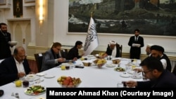 Pakistani national-security adviser Moeed Yusuf speaks to the Taliban's acting deputy prime minister, Abdul Salam Hanafi, (center) in Kabul on January 29. 