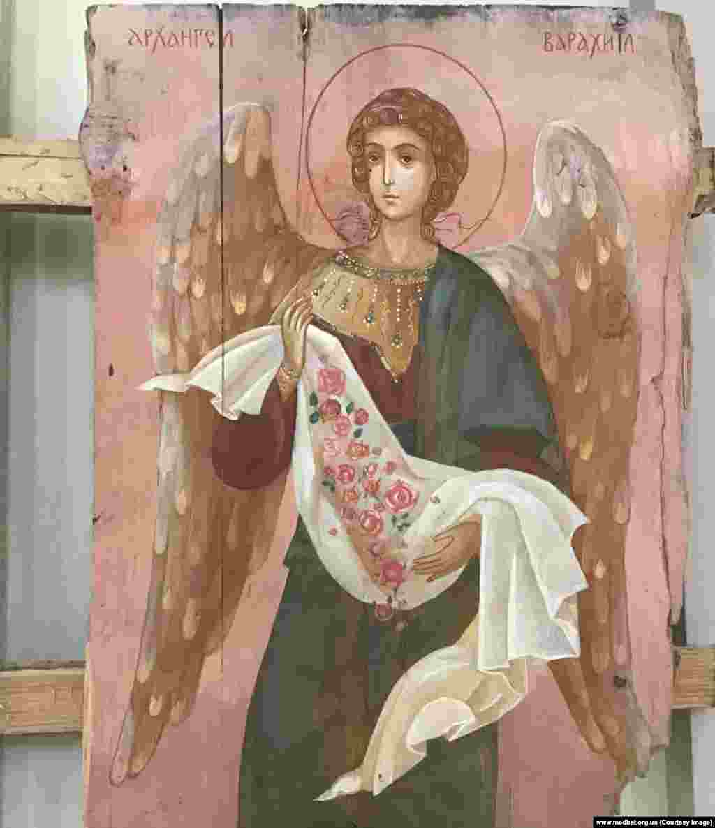 Archangel Barachiel painted on an ammunition-box fragment given to the artist couple by Ukrainian marines stationed in Mariupol, Ukraine. Since 2015, Klymenko and Atlantova have raised more than $300,000 by selling their artwork to help fund a volunteer field hospital in the Donbas region.