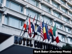 The front facade of the Hotel Continental in Drobeta-Turnu Severin, Romania. The national flags flying over a futuristic fly-out above the front entrance is a hallmark of buildings from the 1960s and '70s. The Continental chain assumed control of many of Romania's communist-era hotels and manages them to this day.