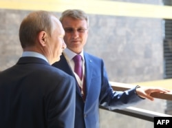 Russian President Vladimir Putin (left) and Sberbank President German Gref (file photo)