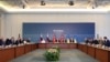Members of Ukrainian (R), Russian (L) and Turkish (C) delegations attend peace talks at the Ciragan Palace in Istanbul, June 2, 2025.