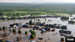 An aerial image of a village on June 26 shows a flash flood caused by heavy rains in the Irkutsk region.