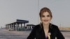 Armenia - A photo of former Vagharshapat Mayor Diana Gasparian juxtaposed against a view of a gas station owned by her father-in-law.