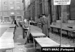 A policeman and a cleaner at work in Budapest in 1960.