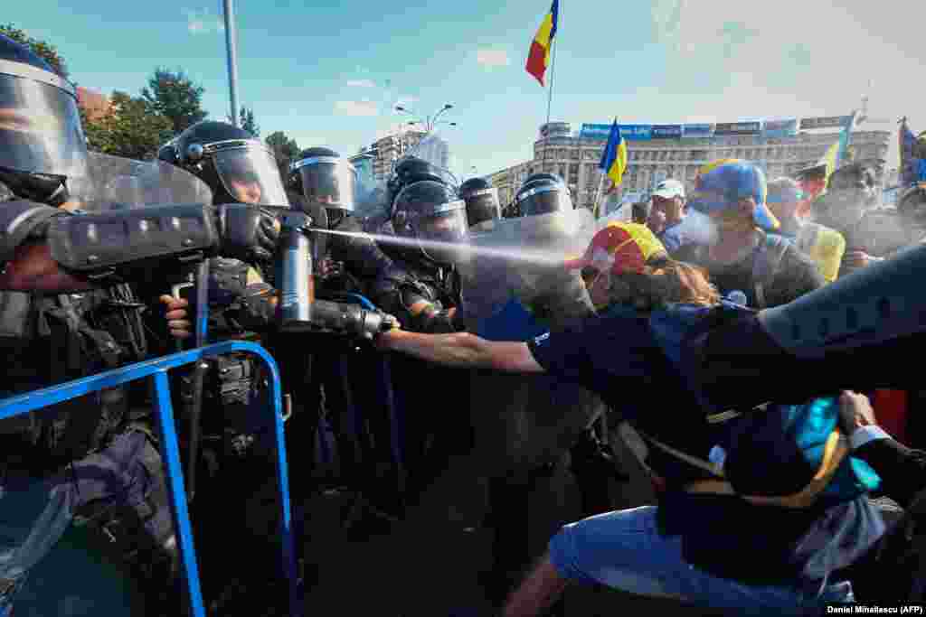 A jet of chemical spray catches a protester on August 10. 