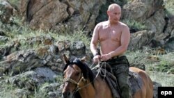 Then-Russian Prime Minister Vladimir Putin rides a horse during while on vacation in the Republic of Tuva in August 2009.