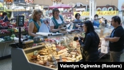 Customers shop for meat products at the Bessarabsky market in central Kyiv.