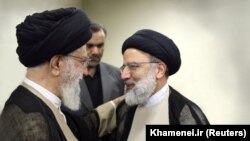 Iranian Supreme Leader Ayatollah Ali Khamenei (left) talks to Ebrahim Raisi in Tehran in March 2019.