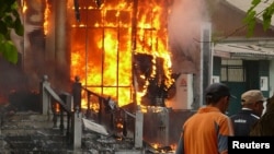 A building burns amid interethnic violence in the city of Osh in June 2010.