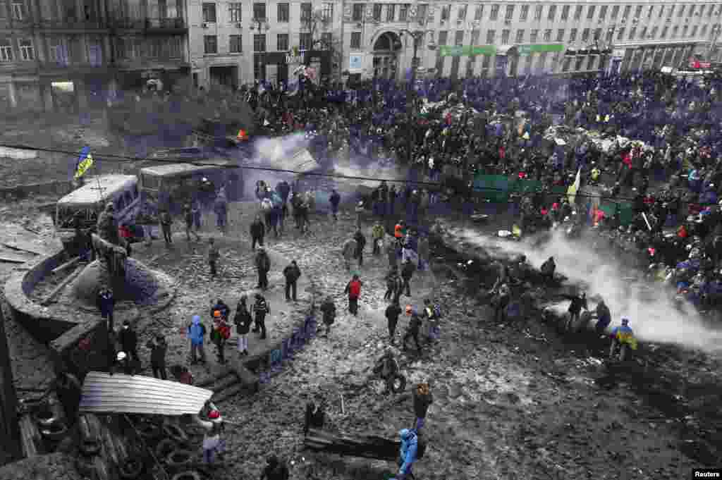 People gather at the the site of clashes between pro-European protesters and riot police in Kyiv on January 23.