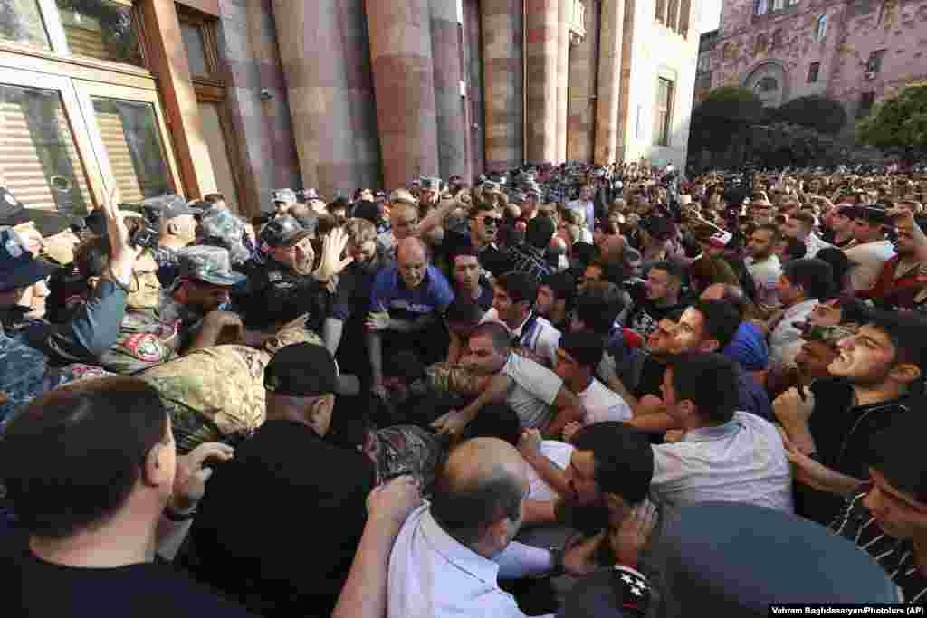 People rally outside the Armenian government building to protest against Pashinian in Yerevan on September 19. Pashinian, who was blamed by nationalists and other critics for losses in the 2020 fighting, noted the cease-fire but immediately distanced his government from its terms. 