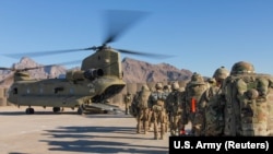 U.S. soldiers load onto a Chinook helicopter to head out on a mission in Afghanistan in January 2019.