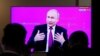 Journalists watch the annual nationwide televised phone-in show with Russian President Vladimir Putin at a press center in Moscow on June 20.