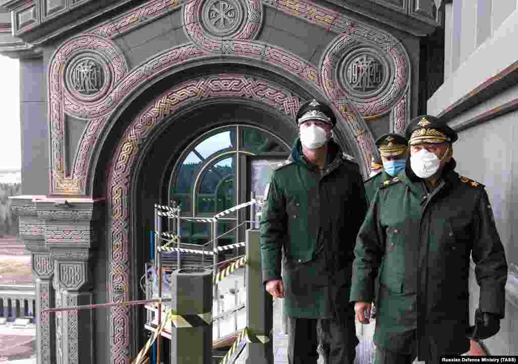 Russian Defense Minister Sergei Shoigu (right) visits the cathedral on April 22. The decorative reliefs in the background mark the start and finish of what Russians call the Great Patriotic War, which began for Soviets in 1941 with the Nazi invasion of the U.S.S.R. and ended with Germany's defeat in Europe in 1945.
