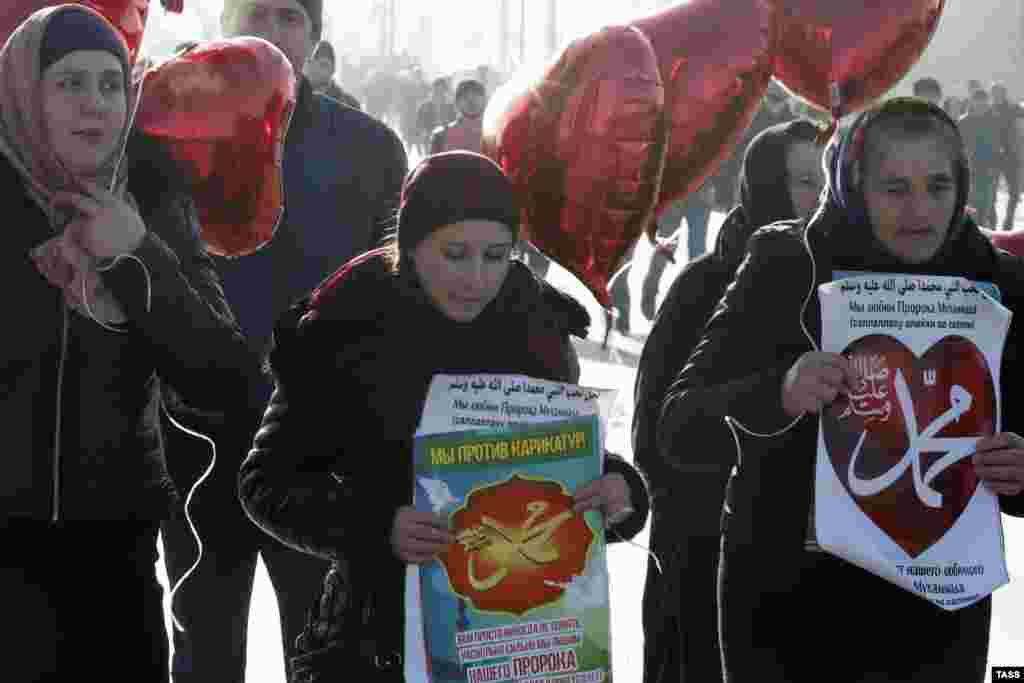 Плакатларда "Без карикатураларга каршы", "Без Мөхәммәт пәйгамбәрне яратабыз" кебек сүзләр язылган иде
