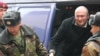 Russian police lead Mikhail Khodorkovsky out of a police van and into a Moscow court on March 4.